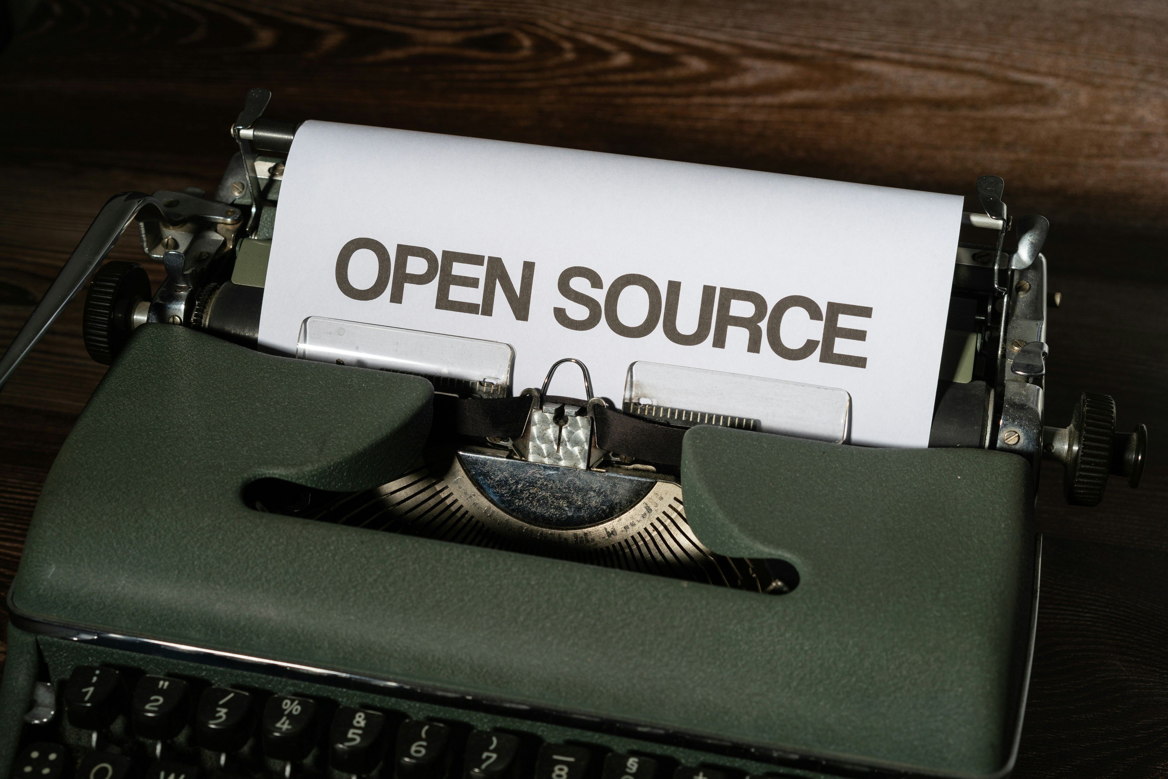 A typewriter with a sheet of paper that reads OPEN SOURCE